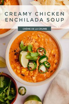 a bowl of creamy chicken enchilada soup with tortilla chips on the side