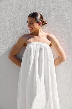 DESIGNED IN AUSTRALIA The Strapless Dress is a midi length, strapless dress made in the IL signature white linen; which is fairly lightweight, with a soft buttery hand-feel. This dress is fully lined in lightweight cotton; designed to fit firmly around the upper bust with a statement band and features a centre back invisible zipper closure. SHIPPING + RETURNS: Please allow 1-3 days for delivery (depending on location) CARE INSTRUCTIONS: Cold gentle hand wash, gentle machine wash or dry clean only.FABRIC: 100% Linen Outer / 100% Cotton Lining SIZING: Model wears size 6. Please check the size guide for measurements. Please check the size guide carefully or email us if you are unsure of your size or have any questions regarding the design or fit. If you are not happy with your IL piece, an ex Linen Outer, White Strapless Dress, Gathered Dress, Pink Peonies, Invisible Zipper, White Linen, Dress Making, Midi Length, Size Guide