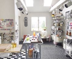 a kitchen filled with lots of counter top space and shelves full of cooking utensils