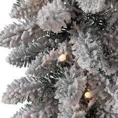 a white christmas tree with snow on it