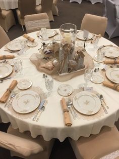 a table set with plates and silverware for an elegant dinner party or function in a banquet hall