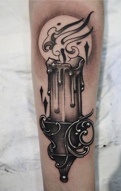 a black and white photo of a tattoo on someone's arm with a liquid pouring out of it