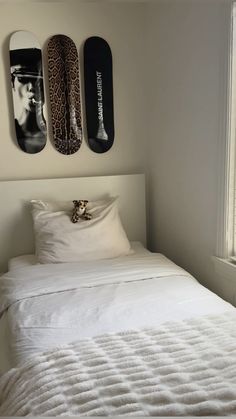 a bed with two skateboards mounted to the wall above it and another pillow on top