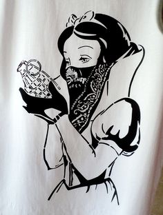 a white t - shirt with a black and white drawing of a woman holding a basket