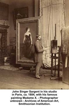 an old black and white photo of a man standing in front of a painting