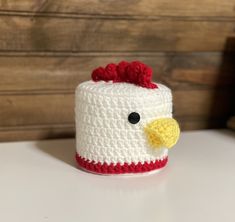 a crocheted chicken is sitting on a table