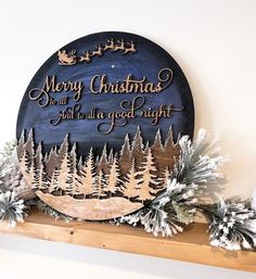 a wooden sign that says merry christmas and it's all good night on the mantle