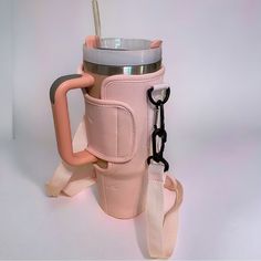 a pink cup with a handle and strap attached to it