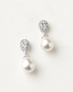 Timeless & stunning, our Nina Pearl & CZ Earrings are the perfect combination of CZs & pearls in a delicate drop. Available in silver, these earrings are perfect for brides & bridesmaids alike. Wear these earrings on your wedding day or special occasion. Elegant Diamond White Pearl Earrings For Wedding, Elegant Crystal Bridal Earrings With Pearl Drop, Elegant White Crystal Pearl Earrings, Timeless Teardrop Cubic Zirconia Bridal Earrings, Elegant Pearl Earrings With Cubic Zirconia, Elegant Diamond White Pearl Bridal Earrings, Classic Pearl Earrings With Cubic Zirconia For Party, Classic Cubic Zirconia Pearl Earrings For Party, Elegant Crystal Pearl Earrings With Sparkling Stones