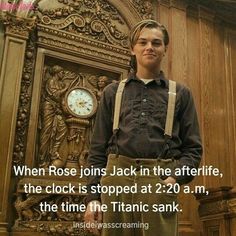 a young man standing in front of a clock