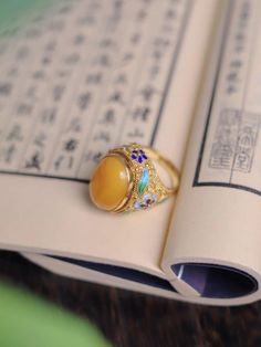 Antique Enamel Ring Jewelry, Vintage Gold Enamel Ring With Gemstone, Vintage Gemstone Enamel Ring As A Gift, Vintage Enamel Gemstone Ring For Gift, Traditional Enamel Jewelry Collectible, Vintage Enamel Jewelry With Gemstone, Vintage Enamel Gemstone Jewelry, Traditional Gold Jewelry With Cabochon, Traditional Hallmarked Enamel Jewelry