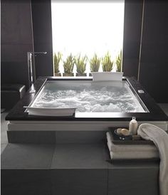 a bath room with a tub and a sink