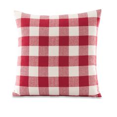 a red and white checkered pillow on a white background