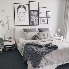 a bedroom with pictures on the wall above the bed