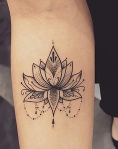 a black and white lotus tattoo on the leg