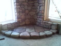 a room with stone walls and steps leading up to the window