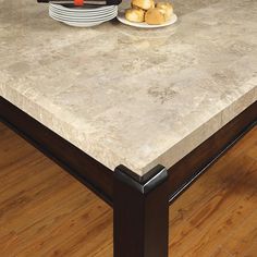 a kitchen table with plates and bowls on it