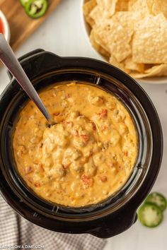 a crock pot filled with salsa and tortilla chips