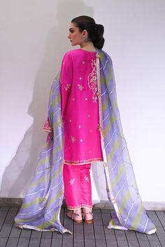 Channeling the old world charm of a kalidar kurta paired with shalwar, Serina is a striking hot pink number cut from pure rawsilk. The undulating trail of the geometric lime green and lavender contrasting organza dupatta hones in the ethereal aura. Model height: 5'3 Length: 38" Cut: relaxed fit In this price range, the Sania Maskatiya, Green And Lavender, Organza Shirt, Indian Designer Suits, Organza Dupatta, Silk Dupatta, Price Range, Silk Organza, Indian Designer