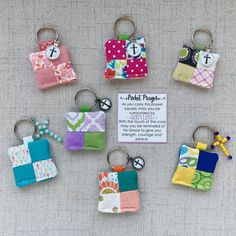 small patchwork purses are on display with a keychain attached to them