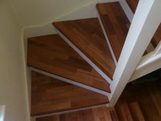 the stairs are made of wood and have white strips on them in order to match the floor