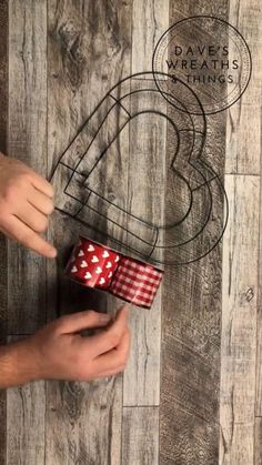 someone is holding two dices in front of a wooden wall with the words love written on it