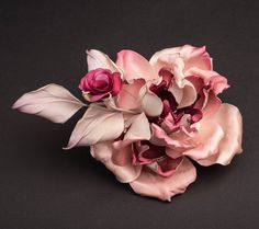 a bouquet of pink and white flowers on a black background