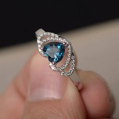 This is a gorgeous handmade creation. Its beauty is its simplicity & Elegance. The 6*6 mm heart cut faceted real London blue topaz is crafted in solid sterling silver and with rhodium plated. All item is sent in a beautiful gift box If you have any idea of design your ring,pls contact me directly. You can realize more lovely stuff clicking the link https://www.etsy.com/shop/knightjewelry?refshopsection_shophome_leftnav Please leave the correct address and you phone number for delivering succ Topaz Birthstone Ring, Blue Topaz Rings, Heart Cut Ring, Topaz Rings, Gem Rings, Rings Heart, Cut Rings, Gemstone Solitaire Ring, Heart Wedding Rings