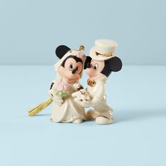 a mickey and minnie mouse figurine holding each other