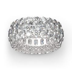 a white gold ring with round cut diamonds in the center and rows of smaller stones on each side