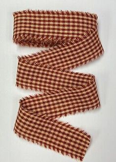 three pieces of red and white checkered fabric with fringes on each side,