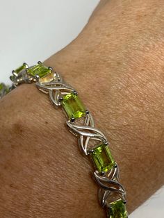 This Peridot bracelet is very lively and bright. The stones are deep colors and well matched. The sterling silver is plated with rhodium to protect the bracelet from tarnish and give the appearance of white gold. 7.5 inches My jeweler can shorten it and he charges a $20 fee All jewelry is shipped in a nice gift box. Check out our over a THOUSAND great reviews Engraving is $4 per letter and is not always perfect depending on the piece. It can take a few days if the jeweler is busy. This is payabl Anniversary Green Sterling Silver Bracelets, Green Sterling Silver Bangle Bracelet, Sterling Silver Green Bracelets For May Birthstone, Green Sterling Silver Bracelets For May Birthstone, Silver Peridot Gemstone Bracelets, Silver Bracelets With Peridot Gemstone, Formal Green Sterling Silver Bracelet, Green Sterling Silver Jubilee Bracelet, Certified Green Sterling Silver Bracelets