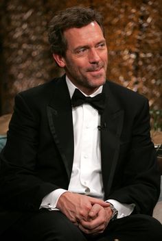 a man in a tuxedo is sitting down