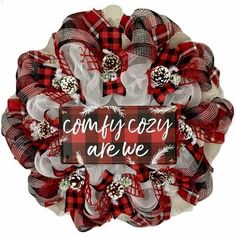 a red and white wreath with the words comfy cozy are we written on it