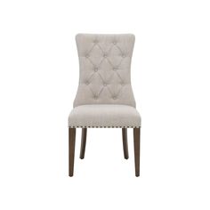 a beige upholstered dining chair with buttons on the back and nail polishing