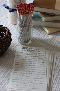 there are many pencils in a glass jar on the table next to some books