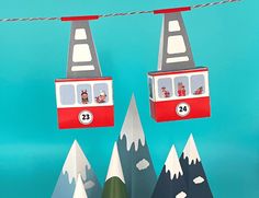 two red and white double decker buses on top of snow covered mountains with trees in the foreground