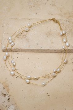 Simple, effortless, dainty freshwater pearl choker designed to go with a wedding gown or with jeans and a tee for date night. Gold Single Strand Chic Pearl Necklace, Chic Gold Single Strand Pearl Necklace, Chic Gold Pearl Choker, Chic Gold Pearl Necklace For Wedding, Gold Pearl Charm Choker For Wedding, Chic Adjustable Gold Pearl Necklace, Chic Gold Pearl Chain Choker, Classic Gold Pearl Choker, Gold Wedding Choker With Pearl Charm