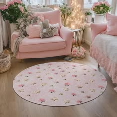 a living room filled with pink furniture and flowers