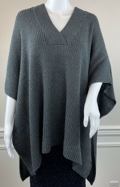 LOFT Charcoal Grey V-Neck Poncho Sweater - Pullover Style - 1/2” of Tack Stitch at Open Sides Create Arm Holes, Side is Completely Open Below Tack Stitching (see photos 3 & 6) - Folded Square/Rectangle Shape - Soft, Rib Knit Acrylic - Size Medium/Large New with tags Please see photos for details - M/L is shown on XS/S mannequin Tag Size: M/L Side to Side Poncho Width Measurement: 37” Top to Bottom Poncho Length Measurement: 28” #X238 One Size Knitted V-neck Sweater, One Size V-neck Knitted Sweater, Casual One Size Knit Poncho, Gray Knit Poncho For Fall, Textured Knit Poncho For Fall, Casual Gray Knit Poncho, One Size Gray Knit Sweater, Cozy Knit Poncho, Layering Poncho In Soft Knit