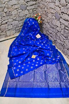 Shop a different appearance for your next party; the only leisurely fabric of chanderi banarasi silk in blue color with unparalleled silver zari lotus buti work on the body, with traditional kadhua weaving on the pallu and the border making this saree one of the unique variety. Color: A shade of blue color Technique: Amazing work of silver zari buti on the body with traditional weaving on the rest of the saree Fabric: Chanderi Silk Quality: Indyvogue's Assurance of Pure Silk Mark Certified Saree Traditional Blue Raw Silk Saree, Blue Raw Silk Saree For Puja, Luxury Blue Silk Saree, Luxury Blue Raw Silk Saree, Blue Silk Thread Saree, Blue Shades Colors, Chanderi Silk Saree, Saree Fabric, Color Techniques