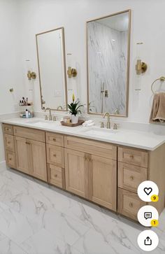 a bathroom with two sinks and mirrors in it