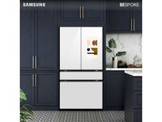 a white refrigerator freezer sitting inside of a kitchen next to blue cabinets and counter tops