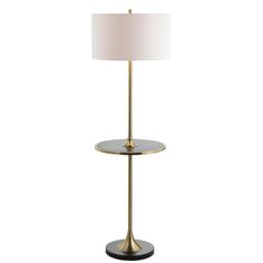 a table lamp with a white shade on top and a black base, sitting next to a