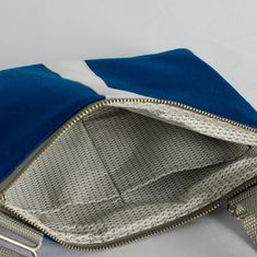 Our crossbody pouch now comes in a stunning blue and white pattern! With a slim profile that expands to hold your keys, phone, card holder and more, this pouch is classic and functional. Upcycled like all of our bags, this crossbody pouch was handcrafted by a woman in recovery and was uniquely designed from a pair of pants worn by the West Point Concert/Marching Band and the Hellcats field music group. Purchase this upcycled, crossbody pouch and create possibilities for women on our team to sust Blue Shoulder Bag With Card Slots For Everyday Use, Blue Shoulder Bag With Cell Phone Pocket For Gift, Everyday Blue Shoulder Bag With Card Slots, Blue Shoulder Bag With Zipper Closure As Gift, Blue Bag With Interior Card Slots For Everyday Use, Blue Rectangular Phone Bag For Everyday Use, Everyday Use Pouch Bag With Wrist Strap, Blue Bags With Interior Card Slots For Everyday Use, Everyday Pouch Bag With Wrist Strap