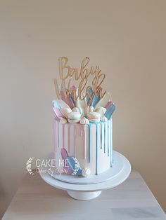 a baby shower cake with pink, blue and white icing