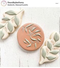 two decorated cookies with leaves on them