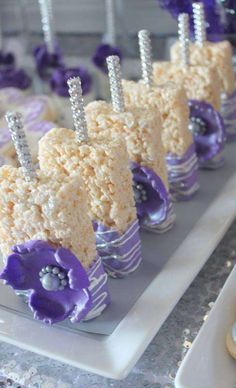 there are many desserts on the plate and one is decorated with purple flower petals