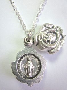 "Miraculous Medal Locket Style Rose Slide Pendant Necklace Rose opens to reveal both sides of a Miraculous Medal. Rose slide medal 3/4\" tall, 1/2\" wide silver tone metal made in Italy 20\" Silver plated 1.75mm cable chain spring ring clasp made in U.S.A. Gift boxed Prayer card included image detail shown" Miraculous Medal Jewelry Gift For Mother's Day, Miraculous Medal Necklace For Mother's Day Gift, Mother's Day Gift Jewelry With Miraculous Medal, Rose Nickel Free Jewelry For Gift, Rose Nickel-free Jewelry For Gift, Rose-colored Nickel-free Jewelry For Gifts, Miraculous Medal, Necklace Rose, Prayer Cards