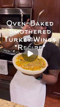 a man holding a bowl of food in front of a stove with the words oven baked smothered turkey wings recipe on it